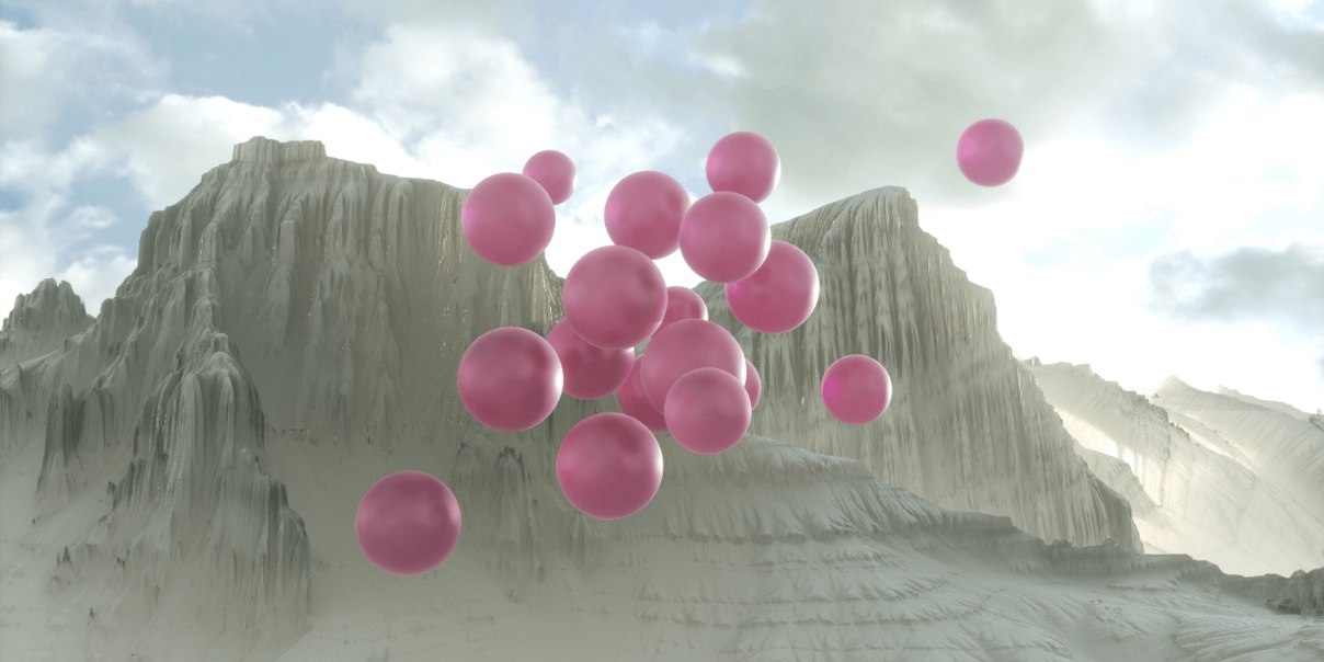 Pink balloons floating around a mountainous landscape under a cloudy sky