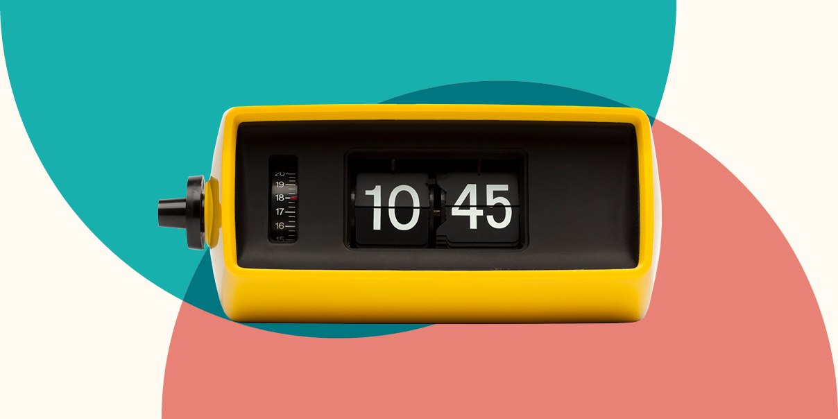 A yellow clock prominently displayed against a vibrant, colorful background, showcasing its bright hue and design.