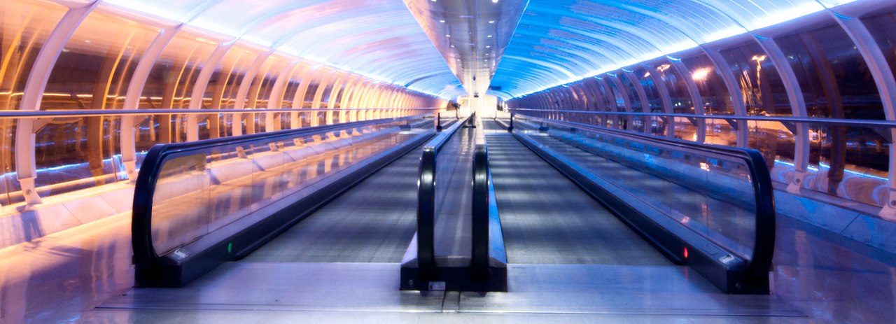 A tunnel linking to Manchester airport terminals taken at night.