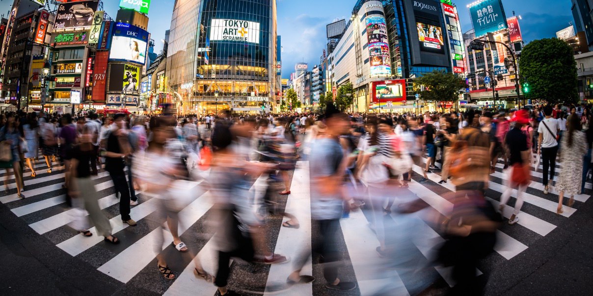 Busy intersection with blurred crowds at Shibuya Crossing in Tokyo