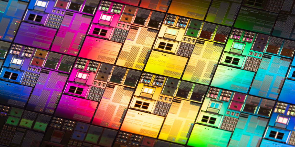 Colorful grid of microchips with intricate electronic patterns and vibrant lighting.