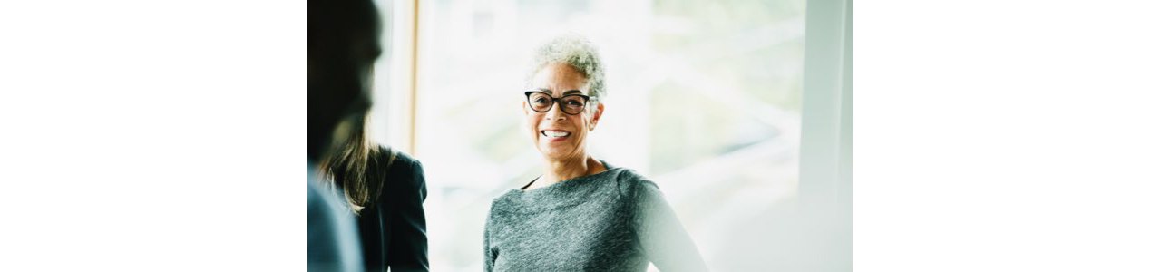Female Financial Adviser with glasses and smiling