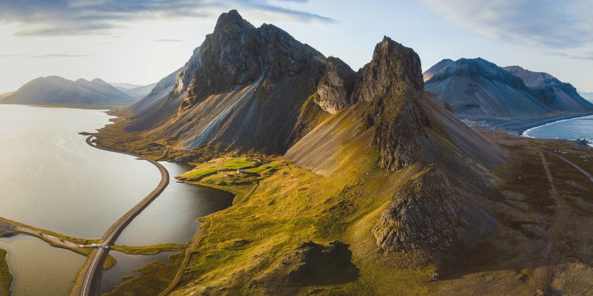 scenic road in Iceland, beautiful nature landscape aerial panorama, mountains and coast at sunset