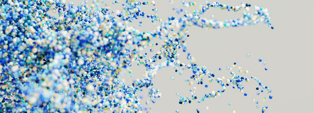 a dynamic abstract composition of small, colorful particles—mostly blue, with hints of green, yellow, and white—floating against a light gray background. The pattern suggests motion and fluidity