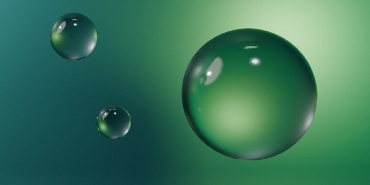 Three green reflective spheres on a gradient background.
