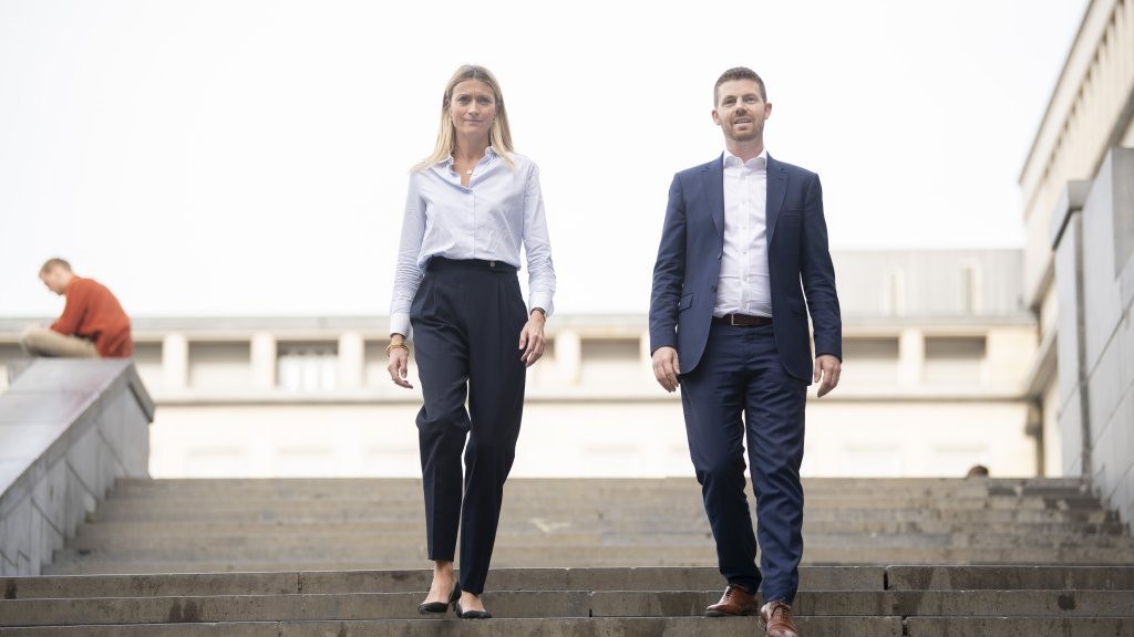 man woman walking down stairs