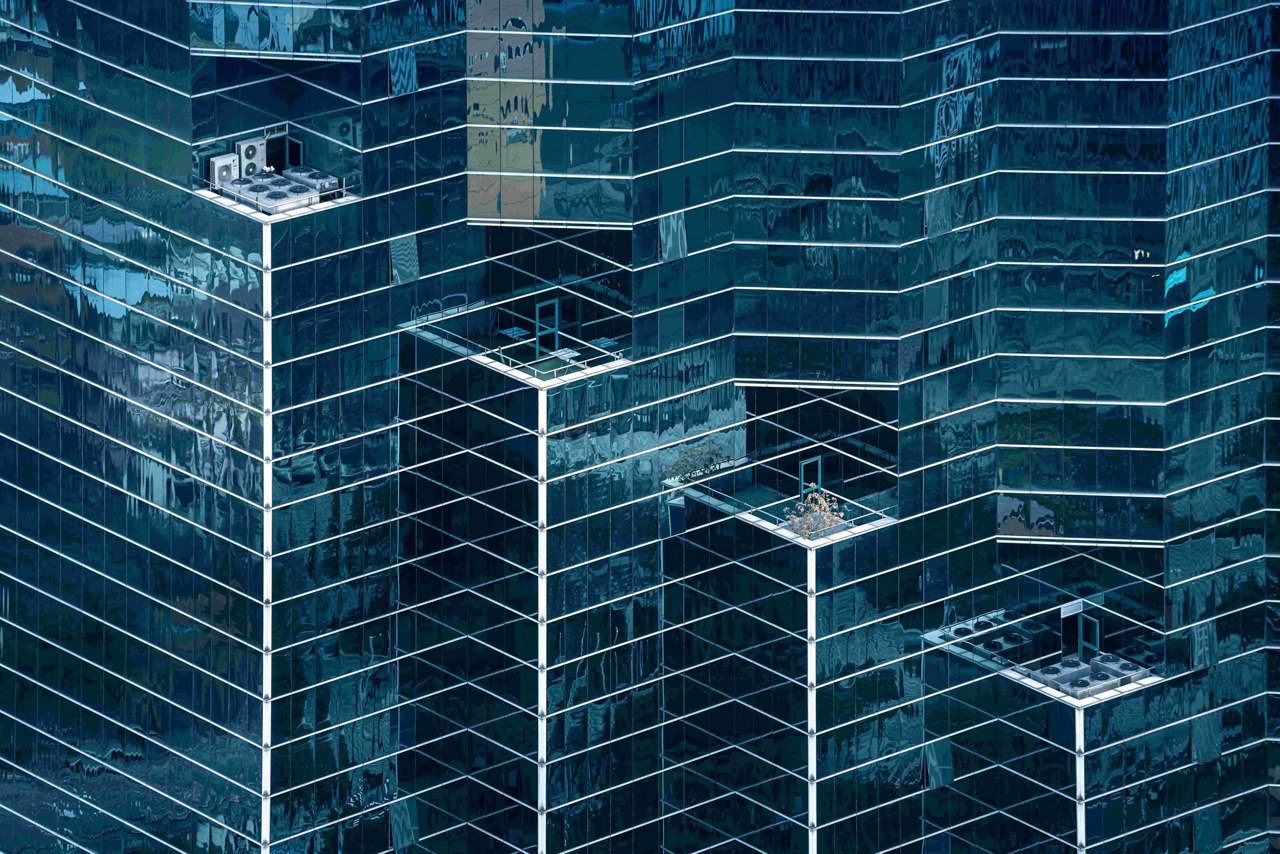 A close-up of modern glass skyscrapers with reflective windows