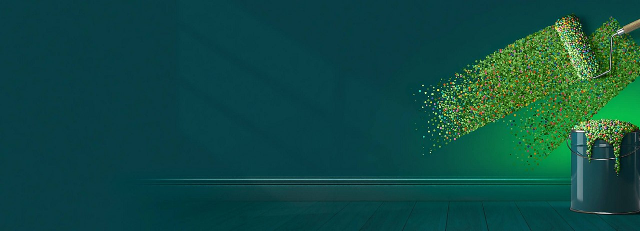 Paint roller applying colourful dots on a teal wall