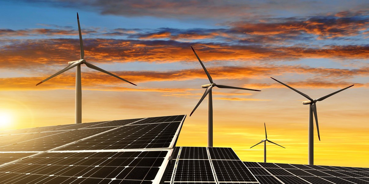 Sunset background with solar panels and wind turbines