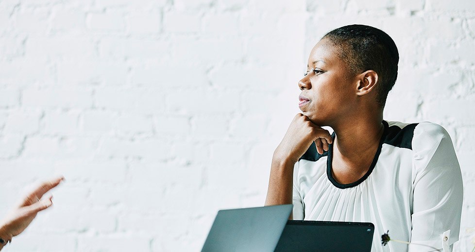 Businesswoman listening to client during meeting in office conference room