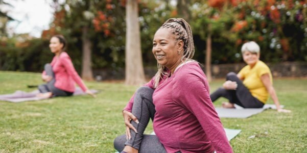 Three women doing yoga outdoors