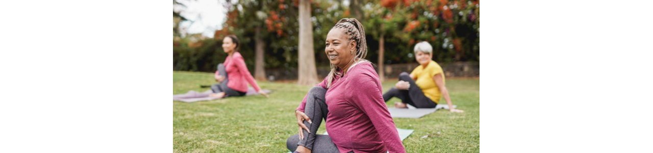 Three women doing yoga outdoors