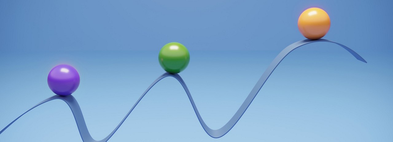 Three spheres on a blue ribbon rising from left to right.