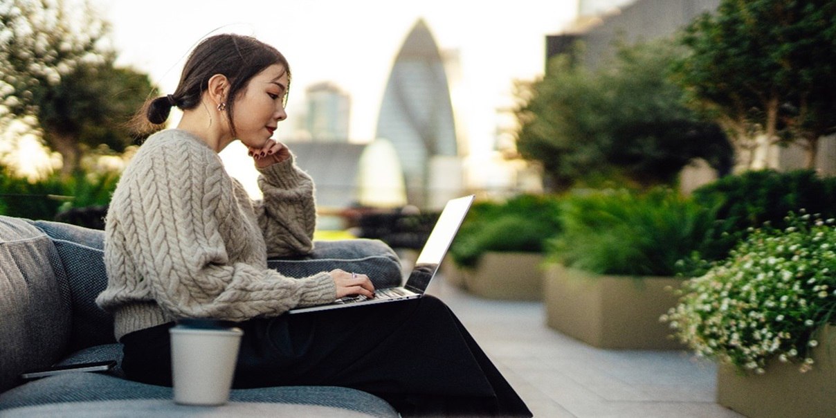 A lady working in a work premises on laptop