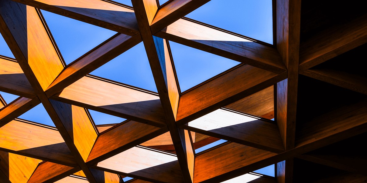 Wooden triangle shaped ceiling windows looking out at blue sky